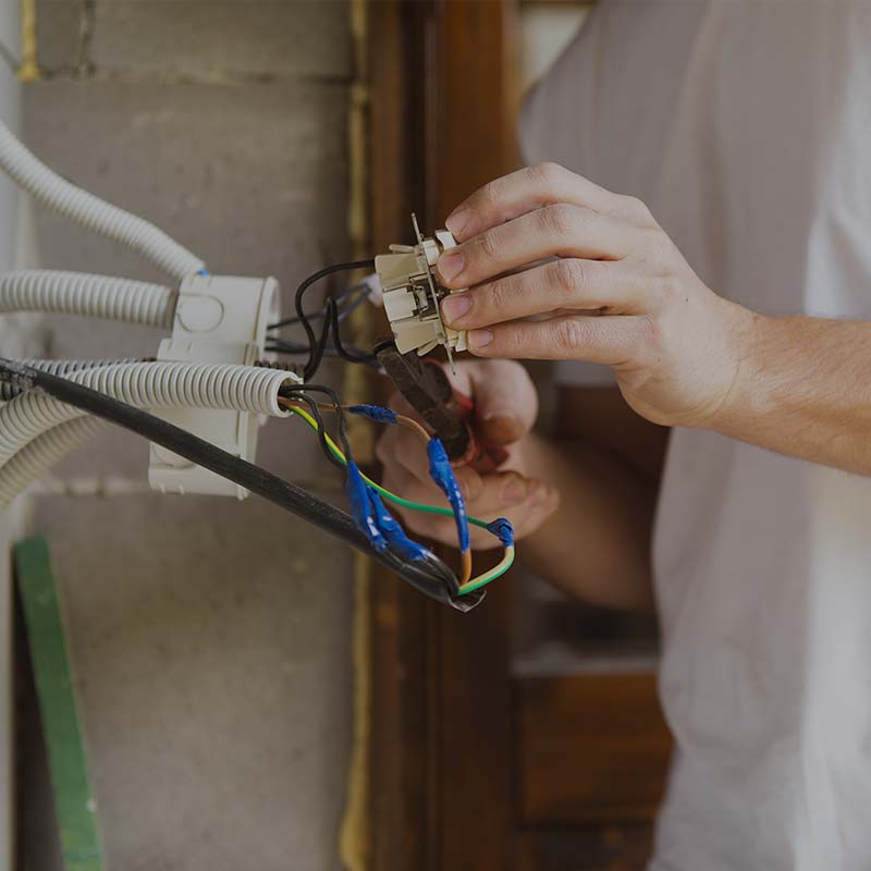 image of man inspecting electrical wiring