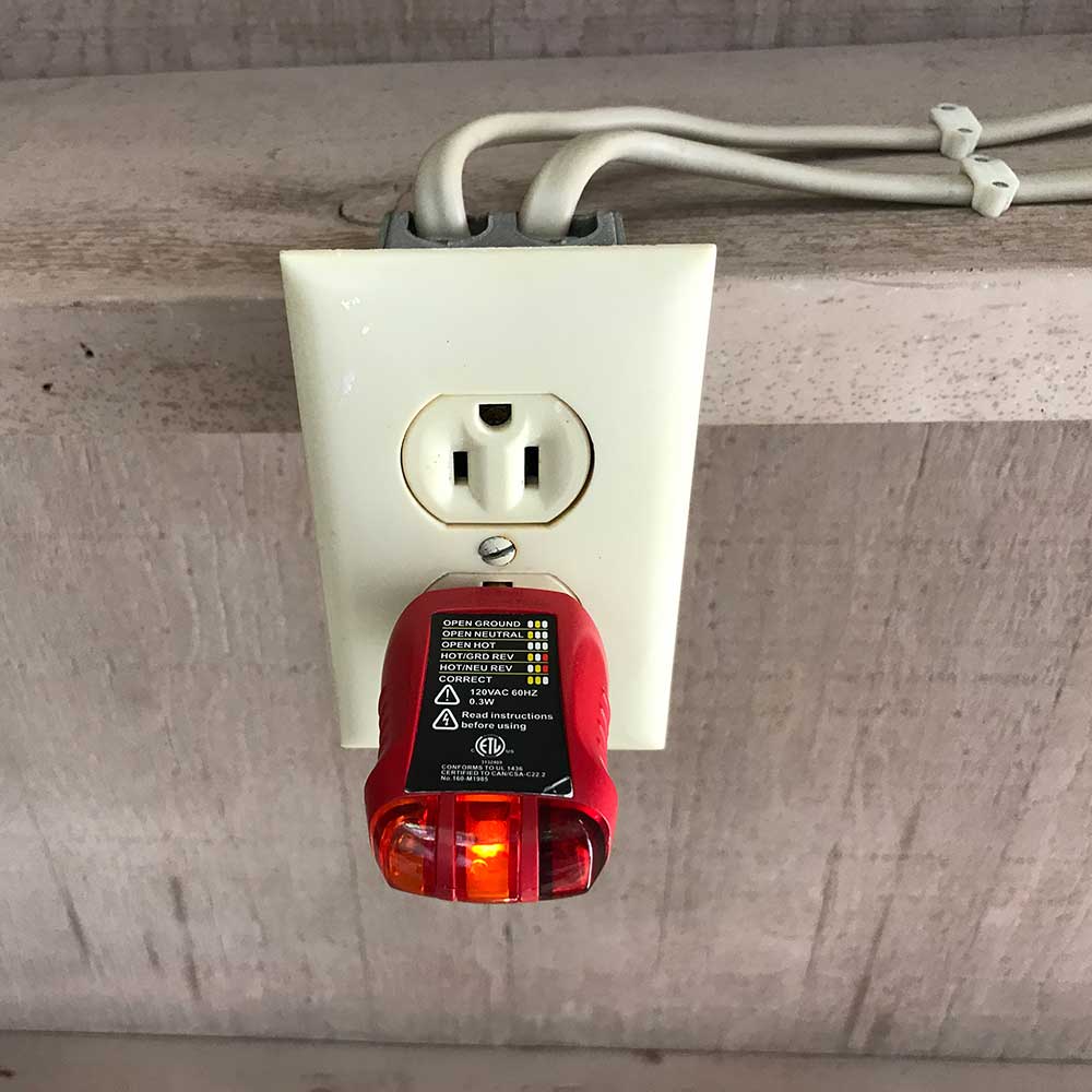 image of testing electric outlet home inspection